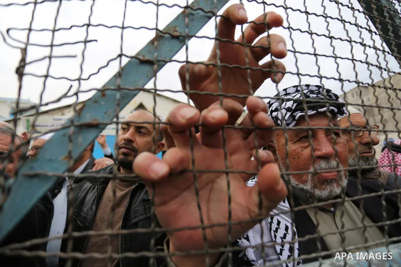 Palestinians take part in a protest against the US move to freeze funding for the UN agency for Palestinian refugees in the southern Gaza Strip town of Rafah on February 6, 2018. Photo by Ashraf Amra
