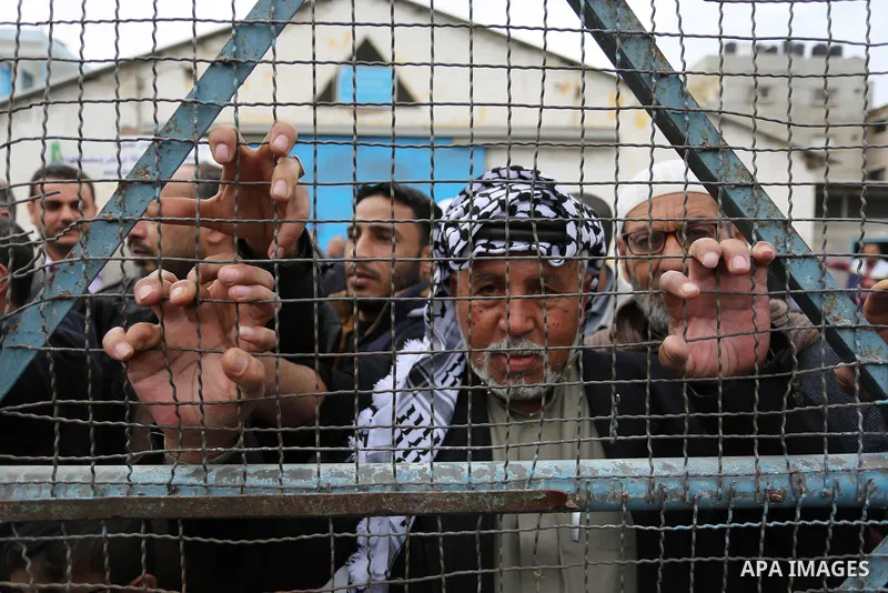 Palestinians take part in a protest against the US move to freeze funding for the UN agency for Palestinian refugees in the southern Gaza Strip town of Rafah on February 6, 2018. Photo by Ashraf Amra