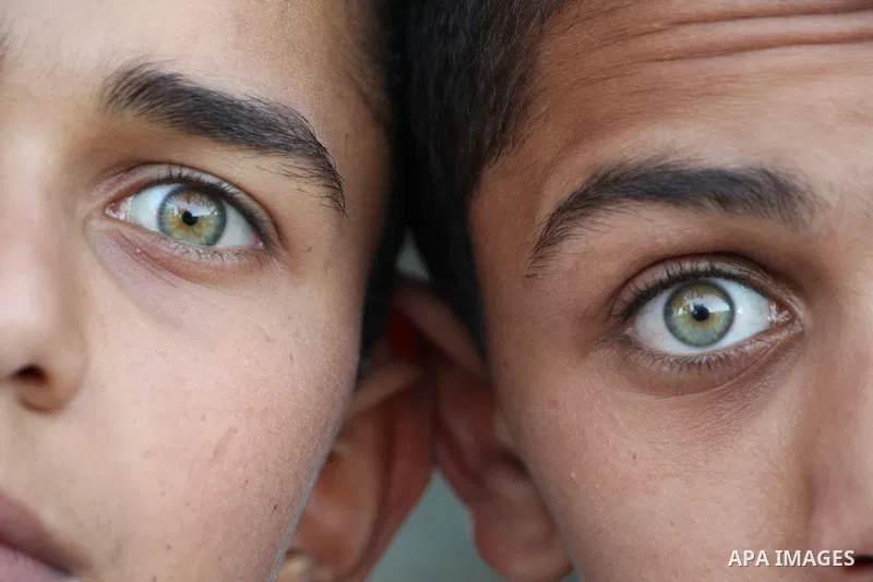 Close up of two boys with green eyes. Photo by Sanad Ltefa