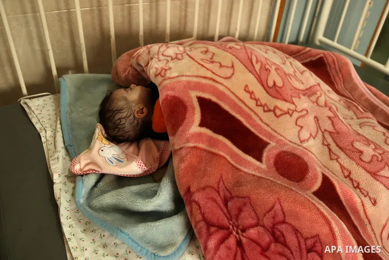 A child is seen in Dora hospital in Gaza City after it stopped its services on February 7, 2018 after it ran out of fuel. Seven medical centers in Gaza have stopped services due to lack of fuel to power generators. Ashra...