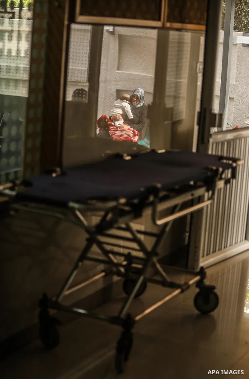The Palestinian child is held by his mother in Dora hospital in Gaza City after it stopped its services on February 7, 2018 after it ran out of fuel. Seven medical centers in Gaza have stopped services due to lack of fue...