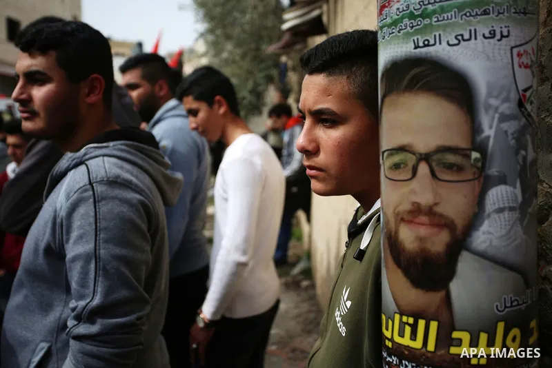 Relatives react during the funeral of Khaled Taeh, a Palestinian, who was shot dead by Israeli during a raid that led to confrontations with residents, in the occupied West Bank city of Nablus, February 7, 2018. Photo by...