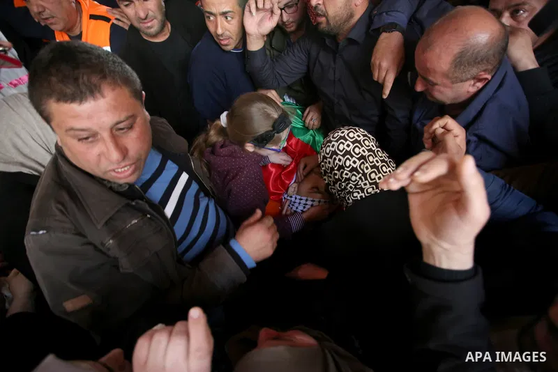 Relatives mourn over the body of Khaled Taeh, a Palestinian, who was shot dead by Israeli during a raid that led to confrontations with residents, during his funeral in the occupied West Bank city of Nablus, February 7,...