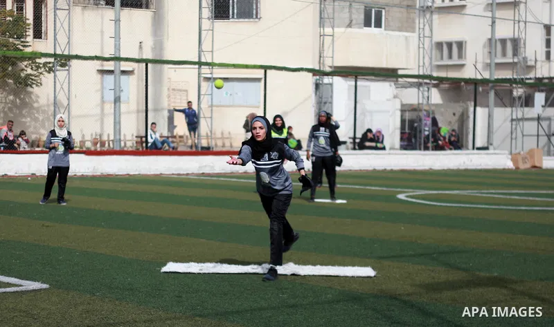 A Palestinian girl in action during the final women's softball game in Gaza city on February 7, 2018. Photo by Mahmoud Ajour