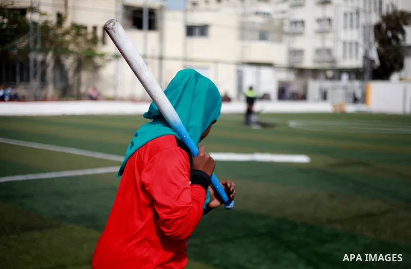 A Palestinian girl in action during the final women's softball game in Gaza city on February 7, 2018. Photo by Mahmoud Ajour