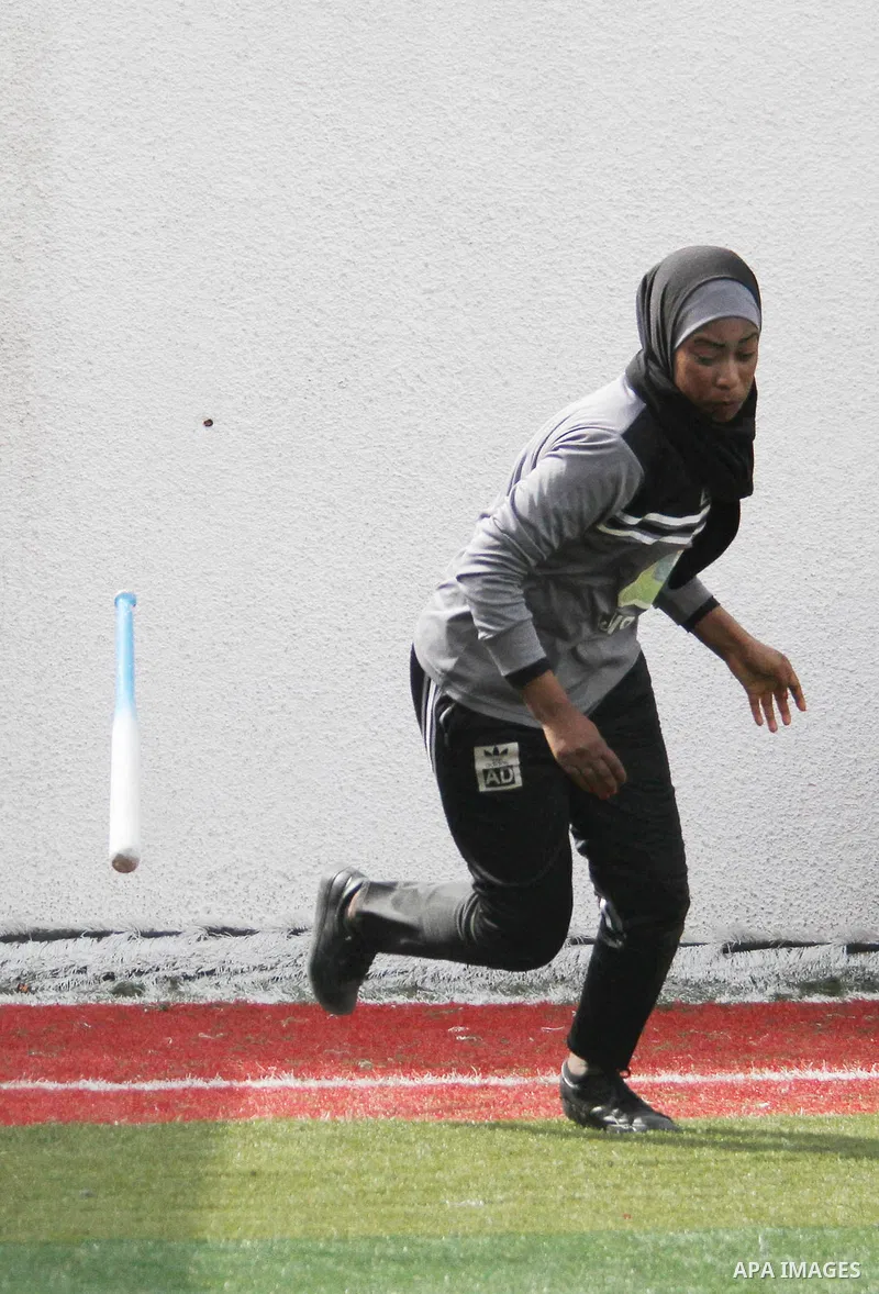 A Palestinian girl in action during the final women's softball game in Gaza city on February 7, 2018. Photo by Mahmoud Ajour