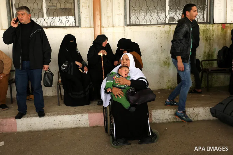 Palestinians wait for travel permits to cross into Egypt through the Rafah border crossing after it was opened by Egyptian authorities for humanitarian cases on the first time in 2018, in the southern Gaza Strip on Febru...