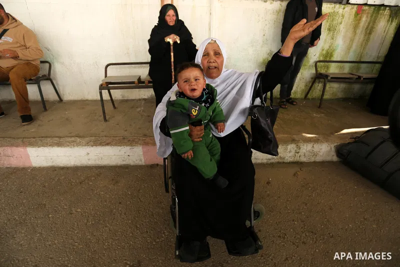 Palestinians wait for travel permits to cross into Egypt through the Rafah border crossing after it was opened by Egyptian authorities for humanitarian cases on the first time in 2018, in the southern Gaza Strip on Febru...