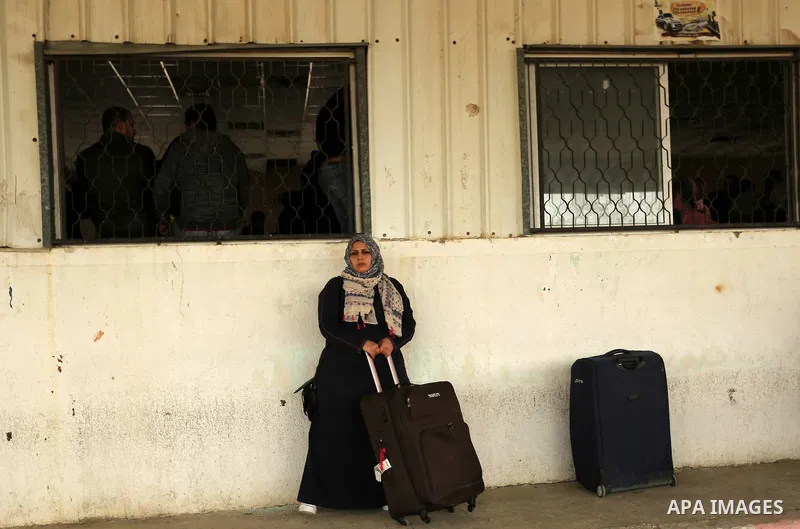 Palestinians wait for travel permits to cross into Egypt through the Rafah border crossing after it was opened by Egyptian authorities for humanitarian cases on the first time in 2018, in the southern Gaza Strip on Febru...