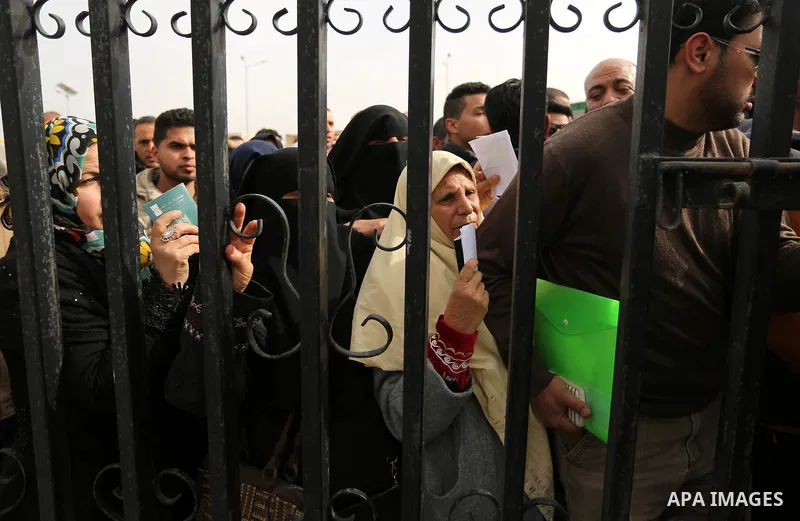 Palestinians wait for travel permits to cross into Egypt through the Rafah border crossing after it was opened by Egyptian authorities for humanitarian cases on the first time in 2018, in the southern Gaza Strip on Febru...