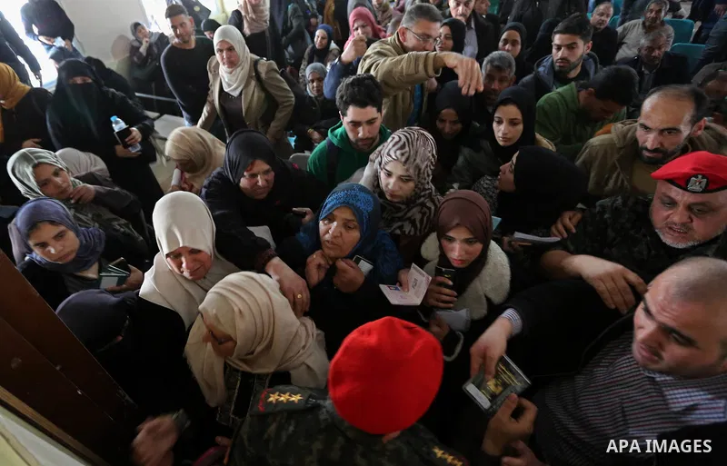 Palestinians wait for travel permits to cross into Egypt through the Rafah border crossing after it was opened by Egyptian authorities for humanitarian cases on the first time in 2018, in the southern Gaza Strip on Febru...