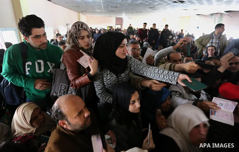 Palestinians wait for travel permits to cross into Egypt through the Rafah border crossing after it was opened by Egyptian authorities for humanitarian cases on the first time in 2018, in the southern Gaza Strip on Febru...