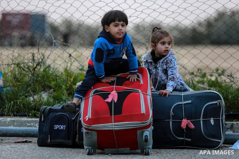 Palestinians wait for travel permits to cross into Egypt through the Rafah border crossing after it was opened by Egyptian authorities for humanitarian cases on the first time in 2018, in the southern Gaza Strip on Febru...