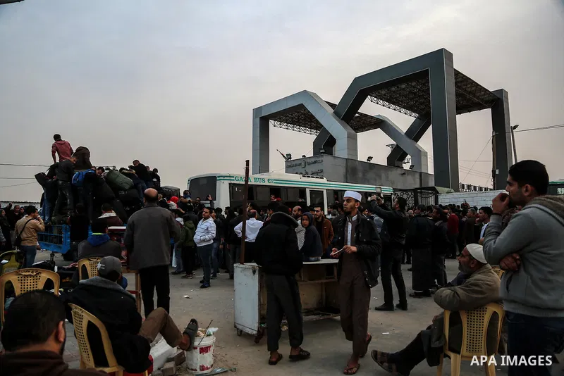 Palestinians wait for travel permits to cross into Egypt through the Rafah border crossing after it was opened by Egyptian authorities for humanitarian cases on the first time in 2018, in the southern Gaza Strip on Febru...