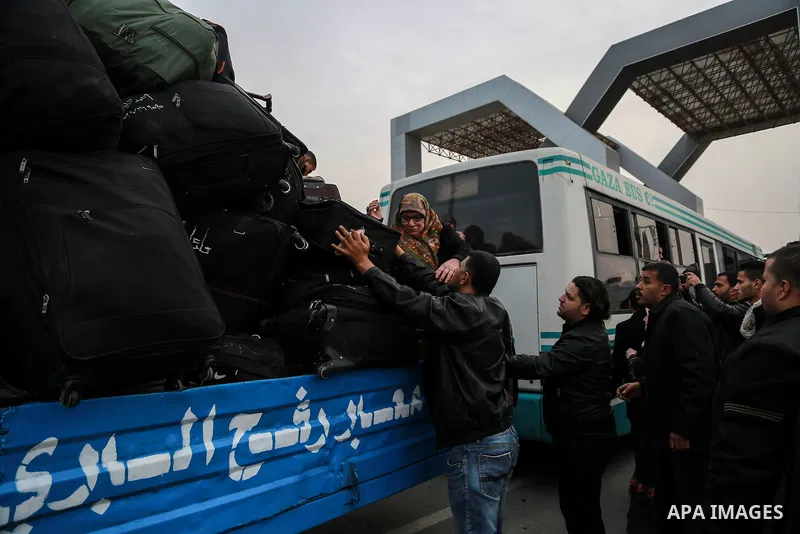 Palestinians wait for travel permits to cross into Egypt through the Rafah border crossing after it was opened by Egyptian authorities for humanitarian cases on the first time in 2018, in the southern Gaza Strip on Febru...