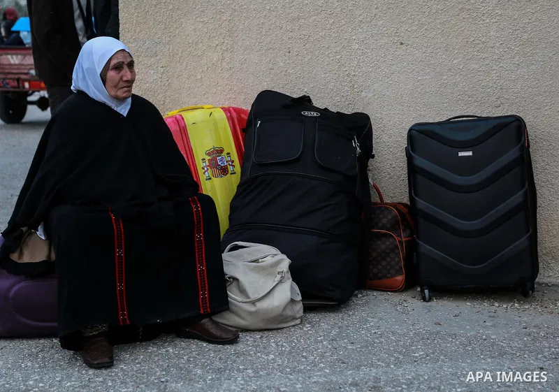 Palestinians wait for travel permits to cross into Egypt through the Rafah border crossing after it was opened by Egyptian authorities for humanitarian cases on the first time in 2018, in the southern Gaza Strip on Febru...