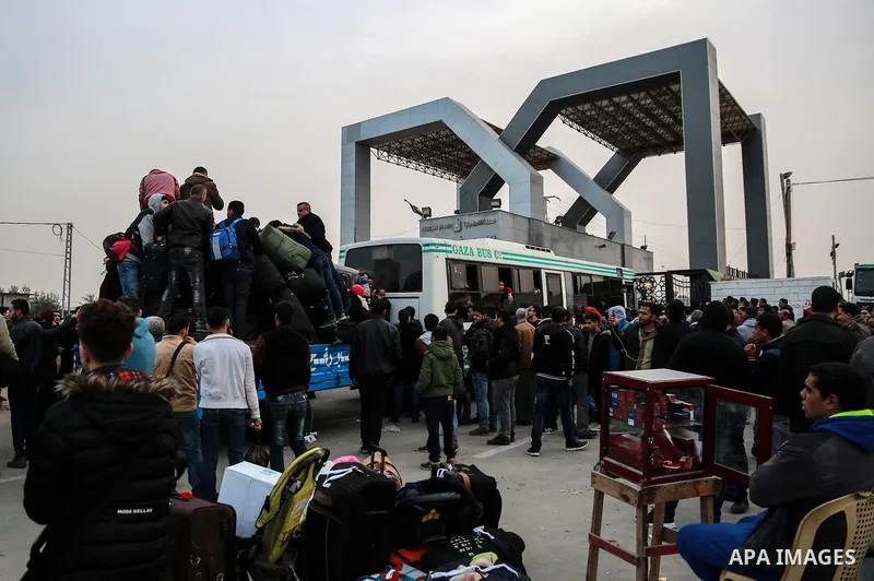 Palestinians wait for travel permits to cross into Egypt through the Rafah border crossing after it was opened by Egyptian authorities for humanitarian cases on the first time in 2018, in the southern Gaza Strip on Febru...