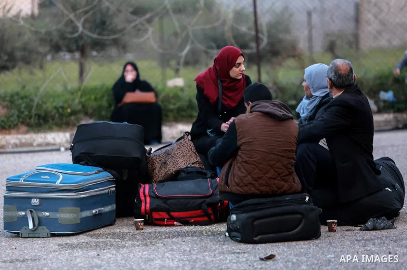 Palestinians wait for travel permits to cross into Egypt through the Rafah border crossing after it was opened by Egyptian authorities for humanitarian cases on the first time in 2018, in the southern Gaza Strip on Febru...