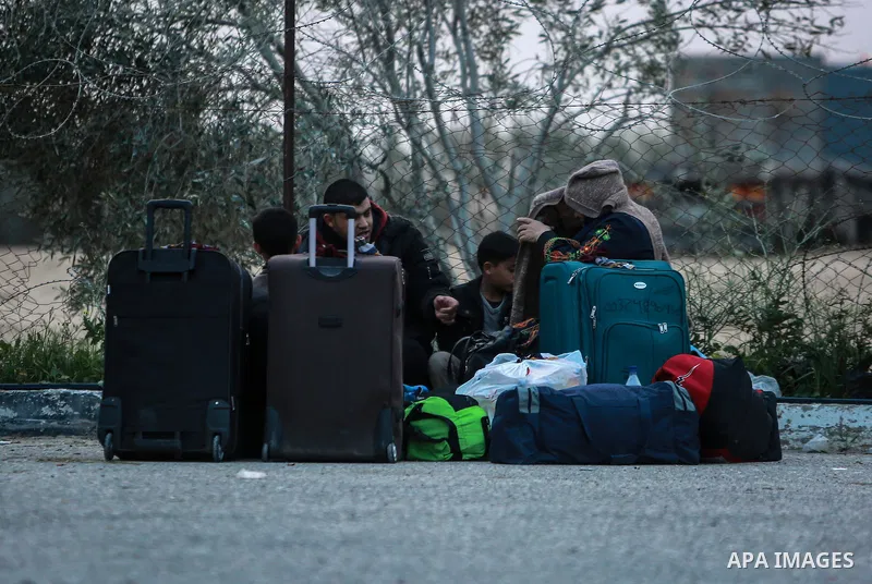 Palestinians wait for travel permits to cross into Egypt through the Rafah border crossing after it was opened by Egyptian authorities for humanitarian cases on the first time in 2018, in the southern Gaza Strip on Febru...