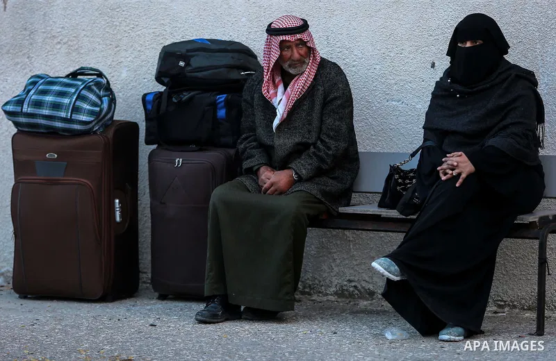 Palestinians wait for travel permits to cross into Egypt through the Rafah border crossing after it was opened by Egyptian authorities for humanitarian cases on the first time in 2018, in the southern Gaza Strip on Febru...