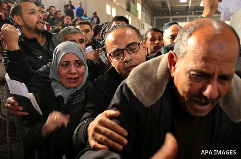 Palestinians wait for travel permits to cross into Egypt through the Rafah border crossing after it was opened by Egyptian authorities for humanitarian cases on the first time in 2018, in the southern Gaza Strip on Febru...