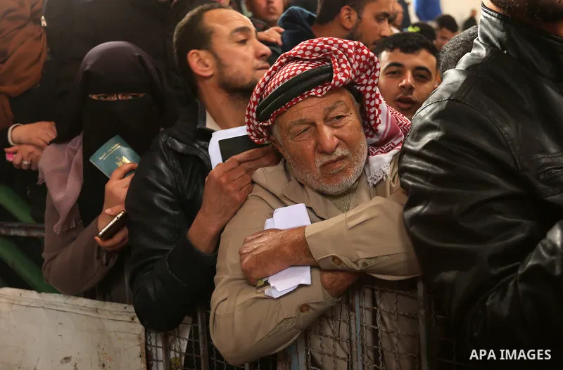 Palestinians wait for travel permits to cross into Egypt through the Rafah border crossing after it was opened by Egyptian authorities for humanitarian cases on the first time in 2018, in the southern Gaza Strip on Febru...