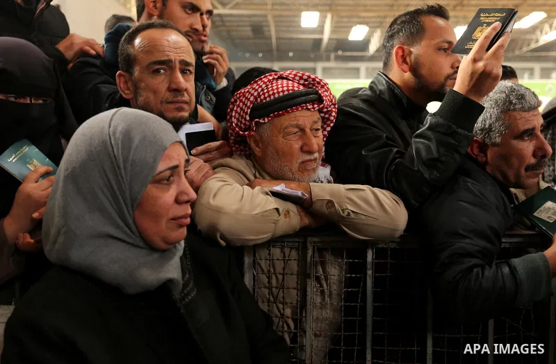 Palestinians wait for travel permits to cross into Egypt through the Rafah border crossing after it was opened by Egyptian authorities for humanitarian cases on the first time in 2018, in the southern Gaza Strip on Febru...