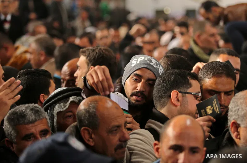 Palestinians wait for travel permits to cross into Egypt through the Rafah border crossing after it was opened by Egyptian authorities for humanitarian cases on the first time in 2018, in the southern Gaza Strip on Febru...