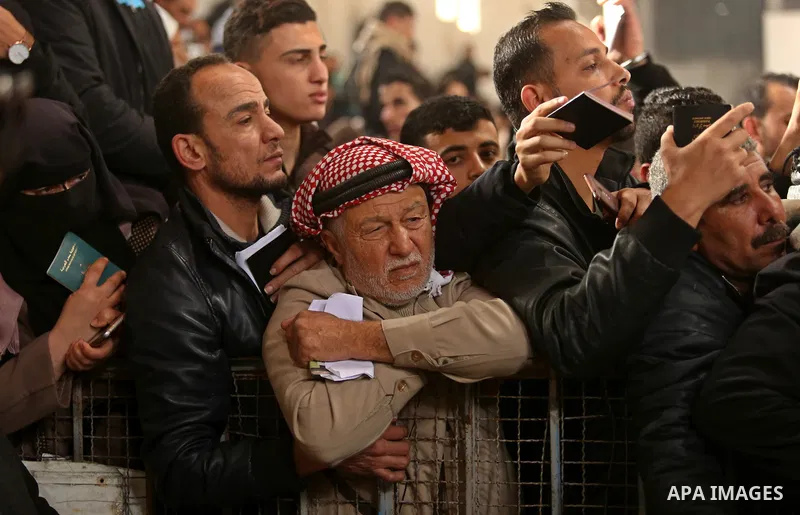 Palestinians wait for travel permits to cross into Egypt through the Rafah border crossing after it was opened by Egyptian authorities for humanitarian cases on the first time in 2018, in the southern Gaza Strip on Febru...