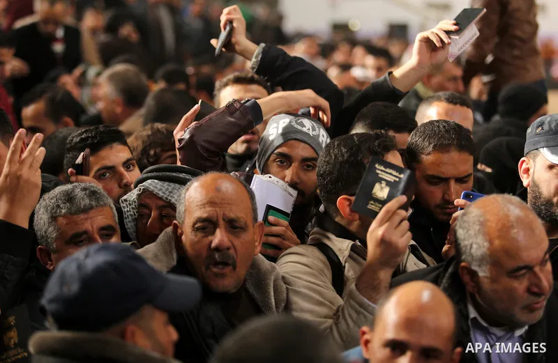 Palestinians wait for travel permits to cross into Egypt through the Rafah border crossing after it was opened by Egyptian authorities for humanitarian cases on the first time in 2018, in the southern Gaza Strip on Febru...