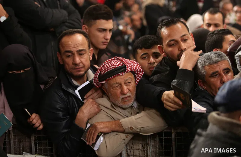 Palestinians wait for travel permits to cross into Egypt through the Rafah border crossing after it was opened by Egyptian authorities for humanitarian cases on the first time in 2018, in the southern Gaza Strip on Febru...