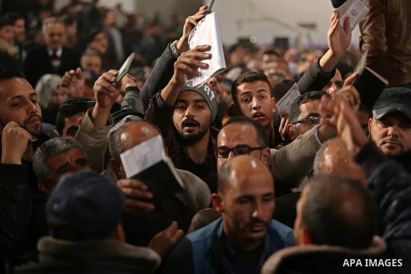 Palestinians wait for travel permits to cross into Egypt through the Rafah border crossing after it was opened by Egyptian authorities for humanitarian cases on the first time in 2018, in the southern Gaza Strip on Febru...