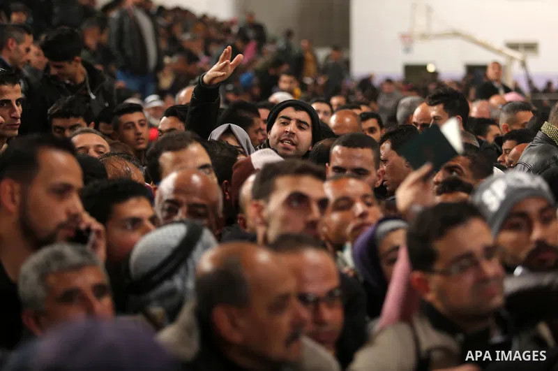 Palestinians wait for travel permits to cross into Egypt through the Rafah border crossing after it was opened by Egyptian authorities for humanitarian cases on the first time in 2018, in the southern Gaza Strip on Febru...