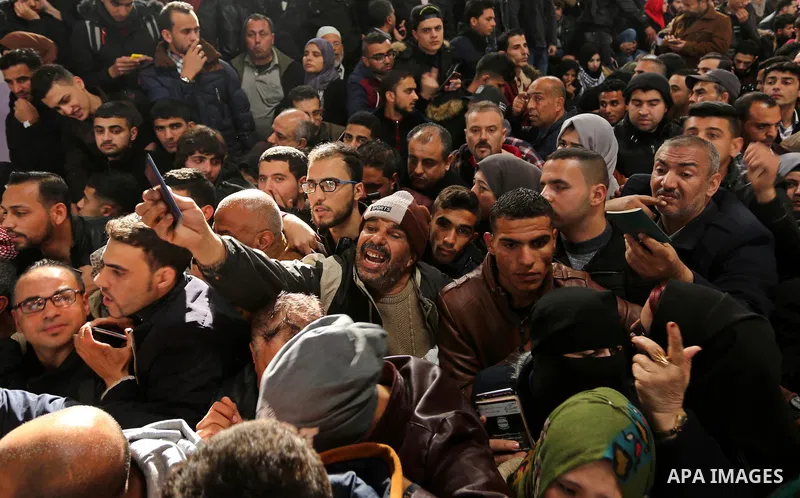 Palestinians wait for travel permits to cross into Egypt through the Rafah border crossing after it was opened by Egyptian authorities for humanitarian cases on the first time in 2018, in the southern Gaza Strip on Febru...