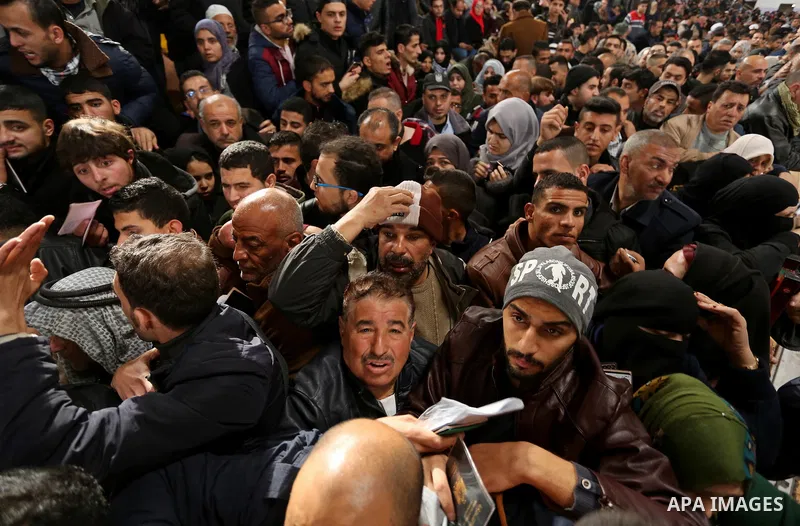 Palestinians wait for travel permits to cross into Egypt through the Rafah border crossing after it was opened by Egyptian authorities for humanitarian cases on the first time in 2018, in the southern Gaza Strip on Febru...