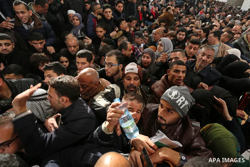 Palestinians wait for travel permits to cross into Egypt through the Rafah border crossing after it was opened by Egyptian authorities for humanitarian cases on the first time in 2018, in the southern Gaza Strip on Febru...