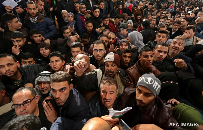 Palestinians wait for travel permits to cross into Egypt through the Rafah border crossing after it was opened by Egyptian authorities for humanitarian cases on the first time in 2018, in the southern Gaza Strip on Febru...