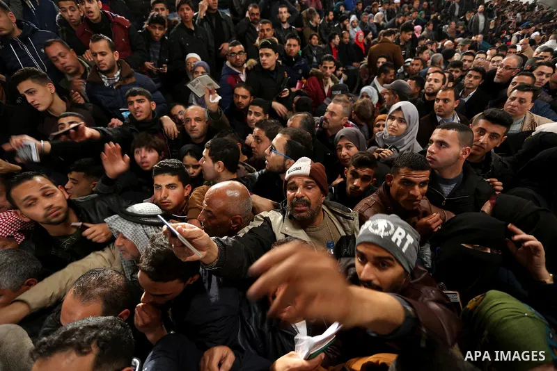 Palestinians wait for travel permits to cross into Egypt through the Rafah border crossing after it was opened by Egyptian authorities for humanitarian cases on the first time in 2018, in the southern Gaza Strip on Febru...