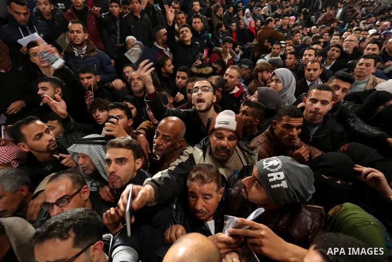 Palestinians wait for travel permits to cross into Egypt through the Rafah border crossing after it was opened by Egyptian authorities for humanitarian cases on the first time in 2018, in the southern Gaza Strip on Febru...