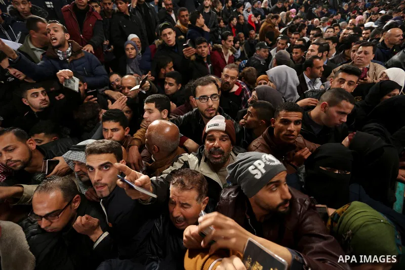 Palestinians wait for travel permits to cross into Egypt through the Rafah border crossing after it was opened by Egyptian authorities for humanitarian cases on the first time in 2018, in the southern Gaza Strip on Febru...