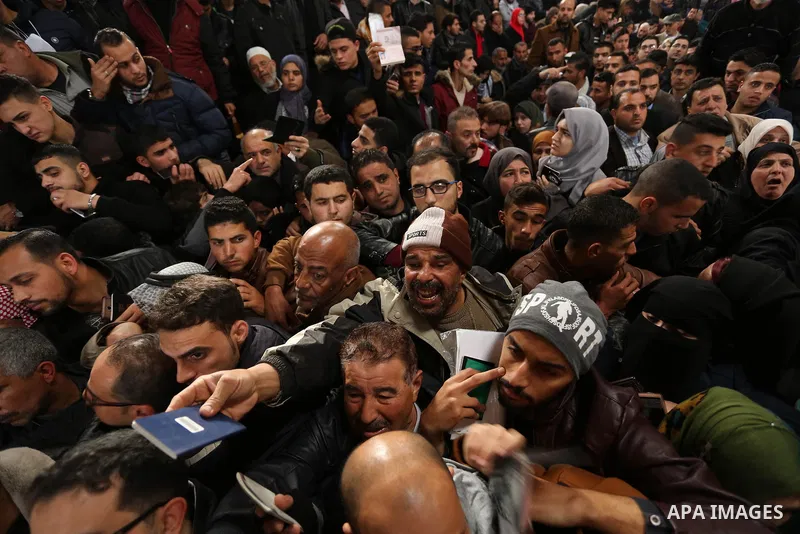 Palestinians wait for travel permits to cross into Egypt through the Rafah border crossing after it was opened by Egyptian authorities for humanitarian cases on the first time in 2018, in the southern Gaza Strip on Febru...