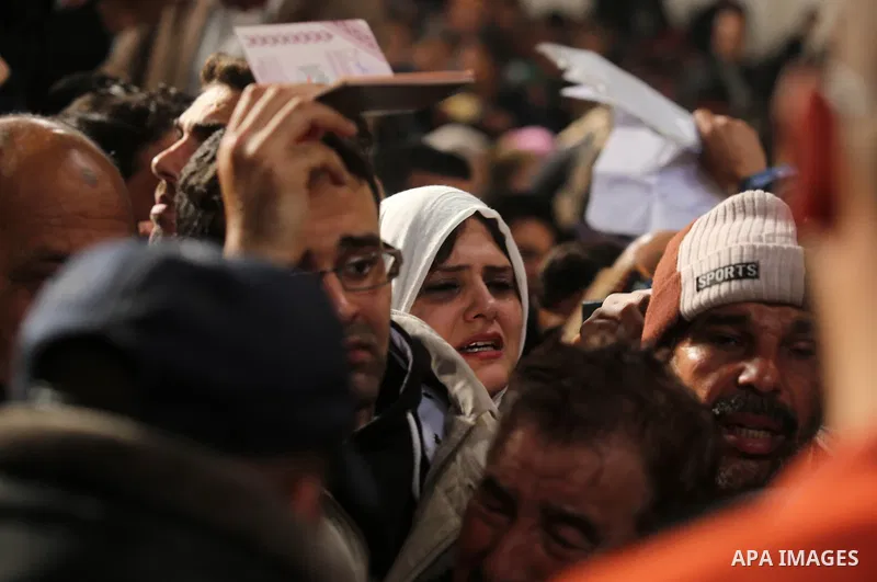 Palestinians wait for travel permits to cross into Egypt through the Rafah border crossing after it was opened by Egyptian authorities for humanitarian cases on the first time in 2018, in the southern Gaza Strip on Febru...