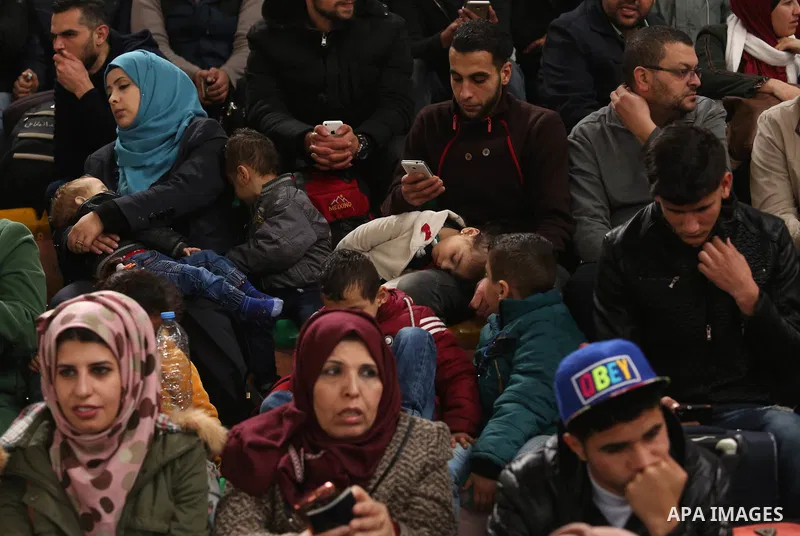 Palestinians wait for travel permits to cross into Egypt through the Rafah border crossing after it was opened by Egyptian authorities for humanitarian cases on the first time in 2018, in the southern Gaza Strip on Febru...