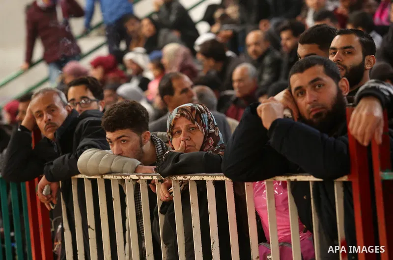 Palestinians wait for travel permits to cross into Egypt through the Rafah border crossing after it was opened by Egyptian authorities for humanitarian cases on the first time in 2018, in the southern Gaza Strip on Febru...