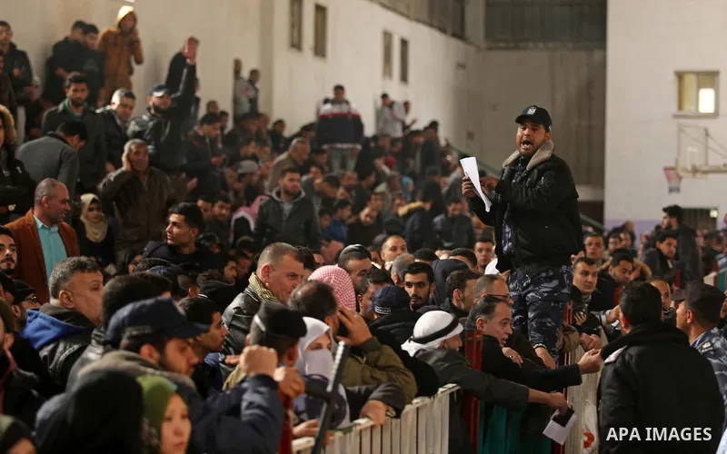 Palestinians wait for travel permits to cross into Egypt through the Rafah border crossing after it was opened by Egyptian authorities for humanitarian cases on the first time in 2018, in the southern Gaza Strip on Febru...