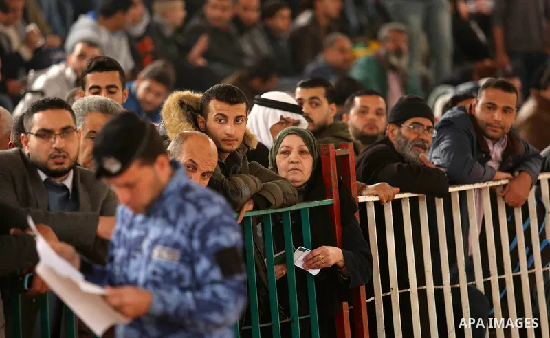 Palestinians wait for travel permits to cross into Egypt through the Rafah border crossing after it was opened by Egyptian authorities for humanitarian cases on the first time in 2018, in the southern Gaza Strip on Febru...