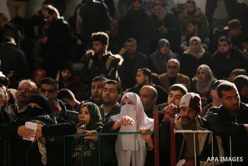Palestinians wait for travel permits to cross into Egypt through the Rafah border crossing after it was opened by Egyptian authorities for humanitarian cases on the first time in 2018, in the southern Gaza Strip on Febru...
