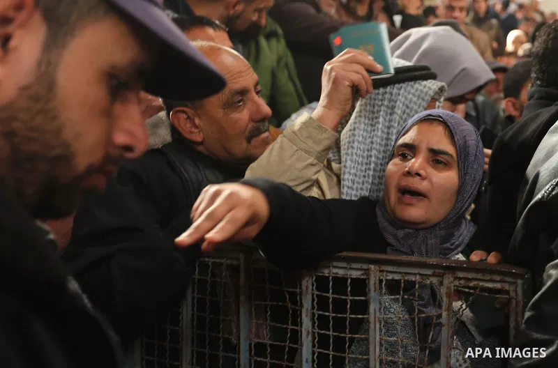 Palestinians wait for travel permits to cross into Egypt through the Rafah border crossing after it was opened by Egyptian authorities for humanitarian cases on the first time in 2018, in the southern Gaza Strip on Febru...