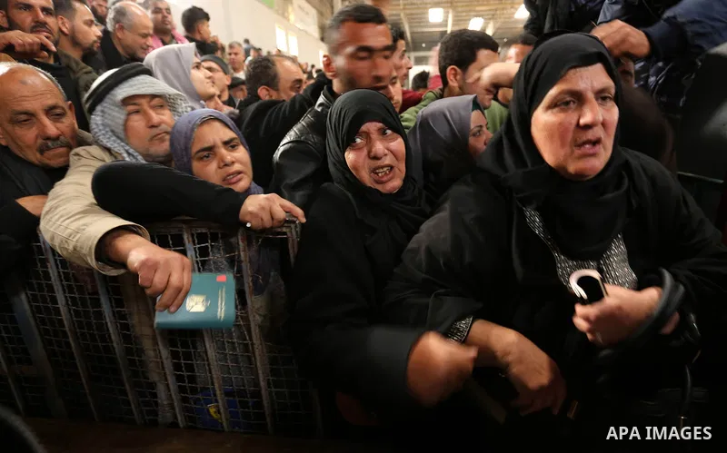 Palestinians wait for travel permits to cross into Egypt through the Rafah border crossing after it was opened by Egyptian authorities for humanitarian cases on the first time in 2018, in the southern Gaza Strip on Febru...