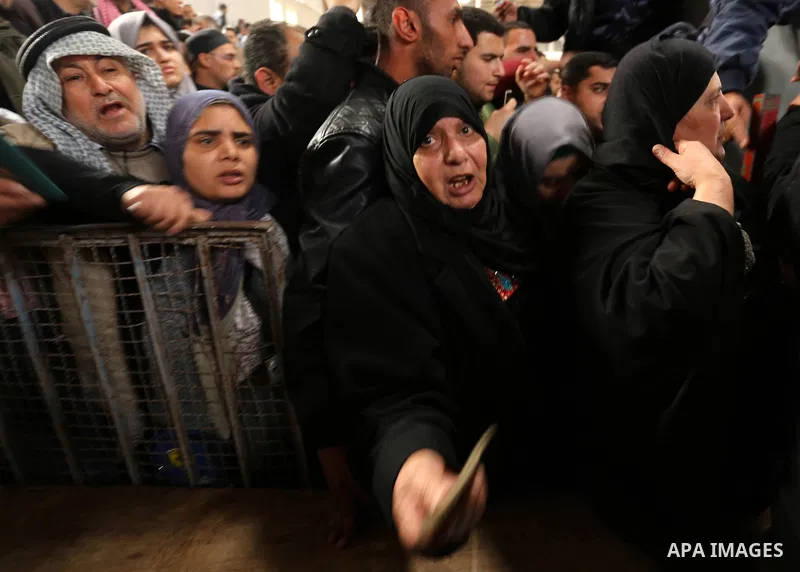 Palestinians wait for travel permits to cross into Egypt through the Rafah border crossing after it was opened by Egyptian authorities for humanitarian cases on the first time in 2018, in the southern Gaza Strip on Febru...